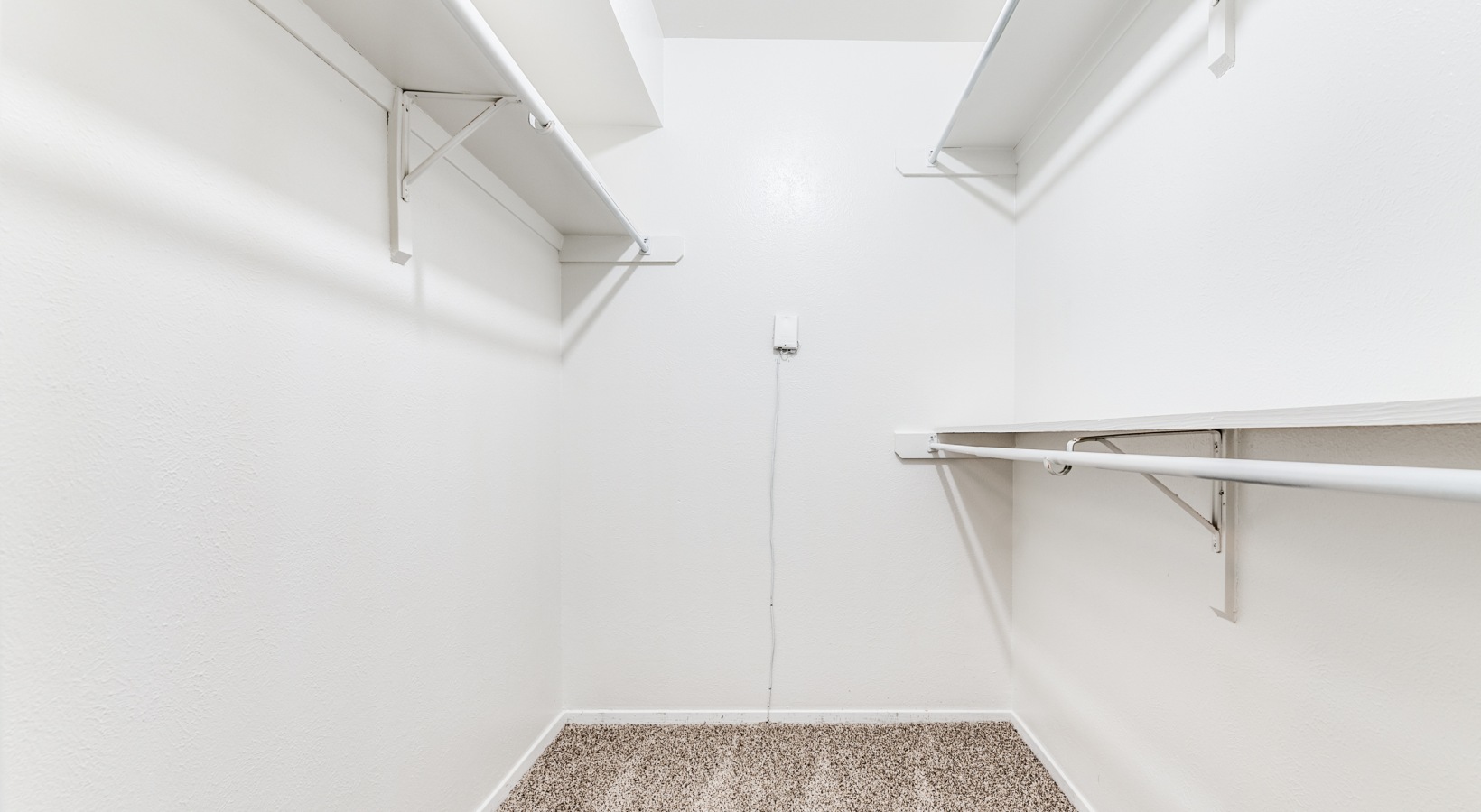 a white closet with shelves and a white floor at The  Kace
