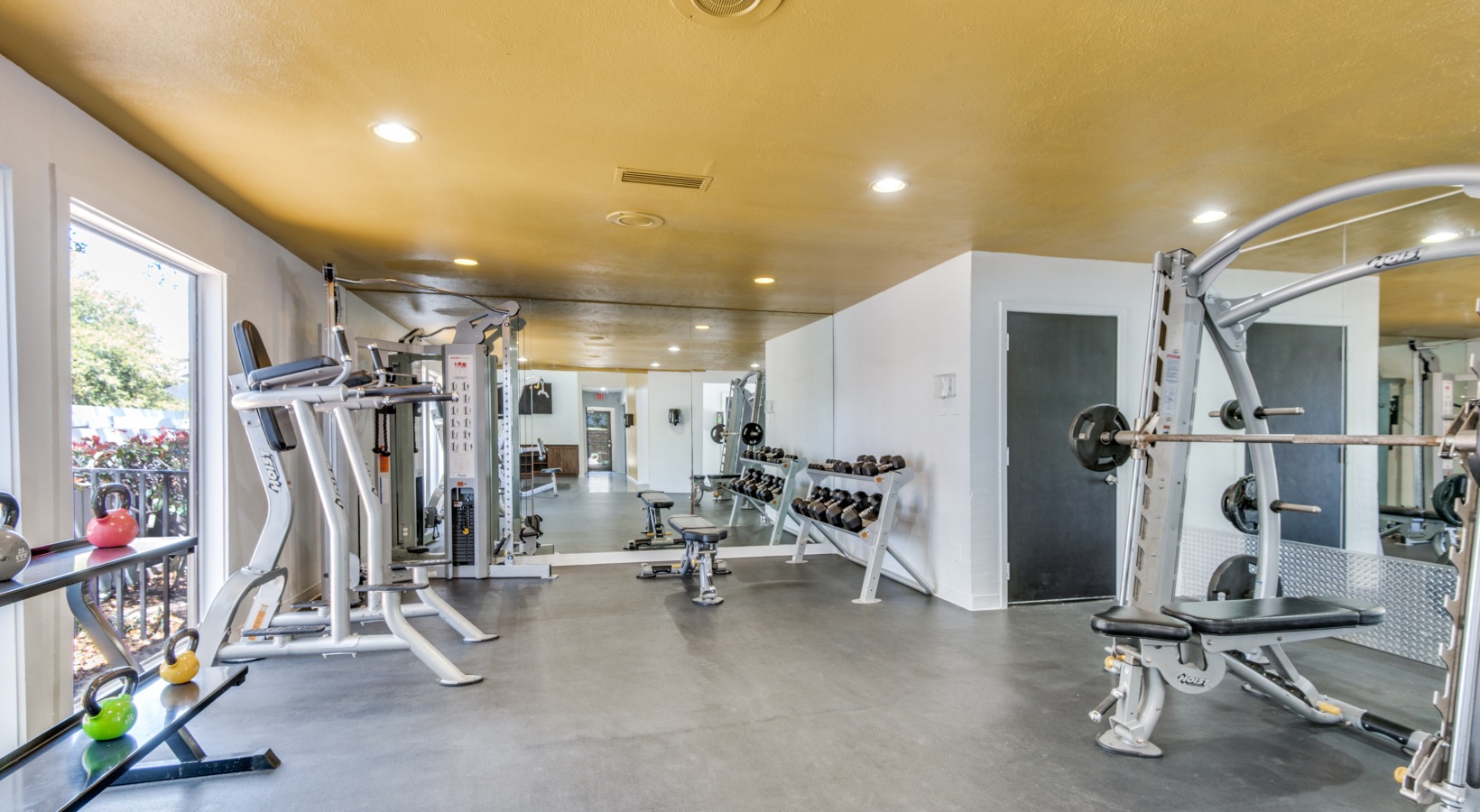 a gym room with a variety of equipment at The  Kace