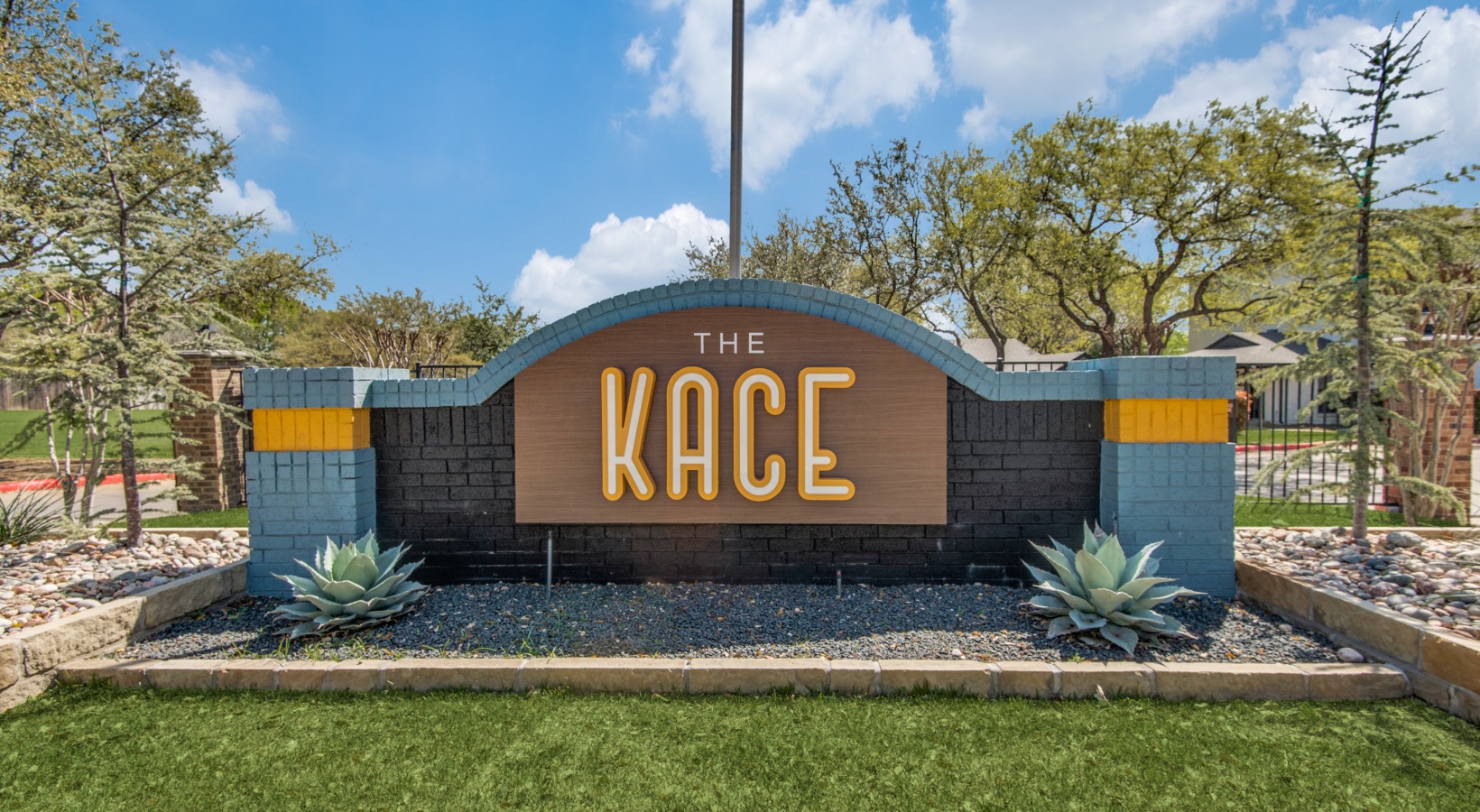the kace sign in front of a grassy area at The  Kace