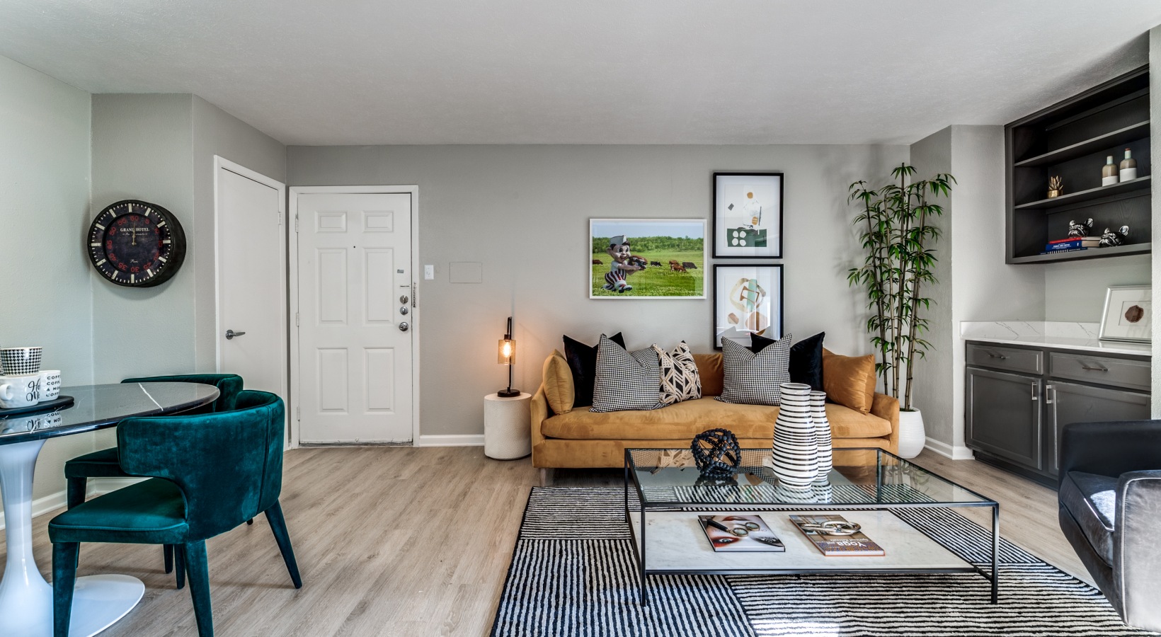 a living room with a couch, coffee table and chairs at The  Kace